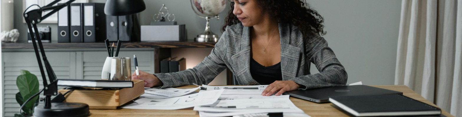 A lady running her own business in her home office running payroll