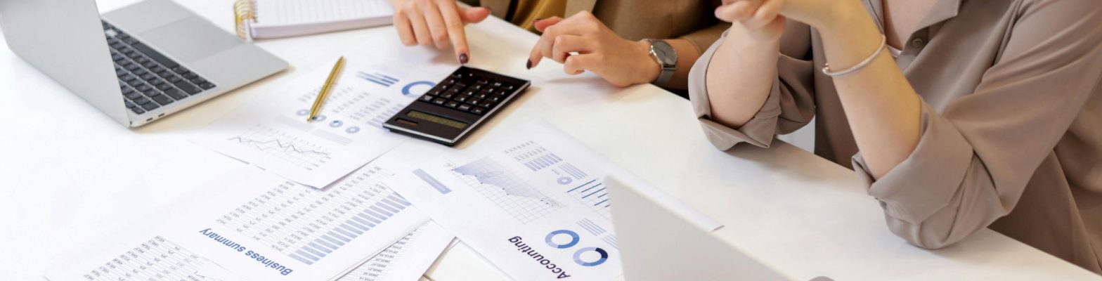 Two finance professionals reviewing SME business growth plans, representing YourFD finance services for SMEs by Coopers&Co. Photo by Artem Podrez via Pexels.