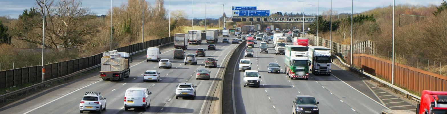 UK motorway with mixed vehicle types during daylight traffic, representing upcoming 2025 UK road tax changes. Photo by Mike Bird via Pexels.